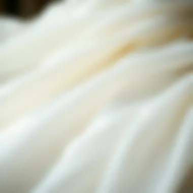A close-up of luxurious fabric textures used in off-white bridal wear