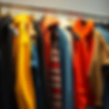 A collection of vibrant used hoodies hanging on a rack, showcasing a variety of styles and colors.