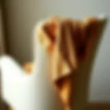 Elegant Draping of the Crop Shrug Cardigan A stylish crop shrug cardigan draped elegantly over a chair, showcasing its texture and design.