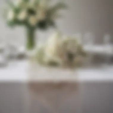 Stylish arrangement featuring white sheer table runner with floral centerpiece